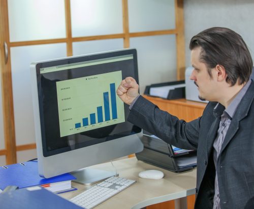 A young businessman working from his office - the concept of success